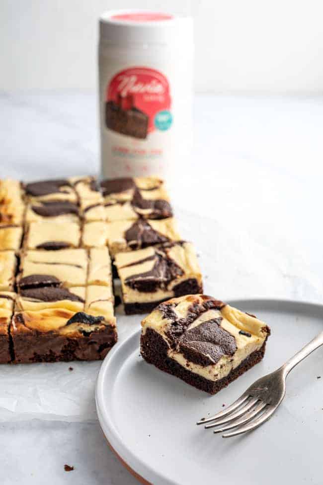 cheesecake brownie on a plate with a fork