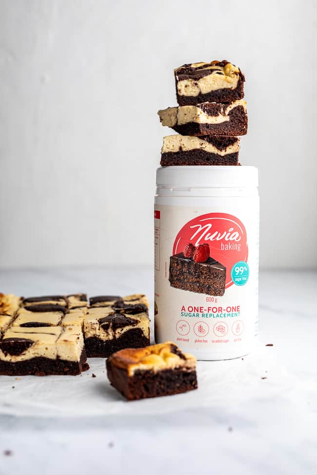 bottle of nuvia baking brand with cheesecake brownies on top.