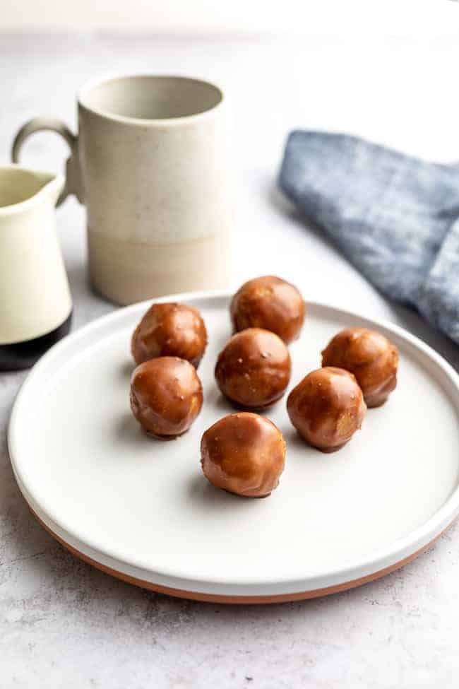 chocolate balls with cup in background